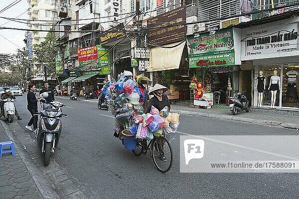Saleswoman with bicycle in the city  Hanoi  Vietnam  Asia