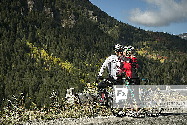 United States  Utah  American Fork  Smiling couple with bicycles taking selfie in mountain landscape