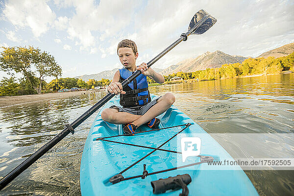 United States  Utah  Highland  Boy (8-9) kayaking on lake