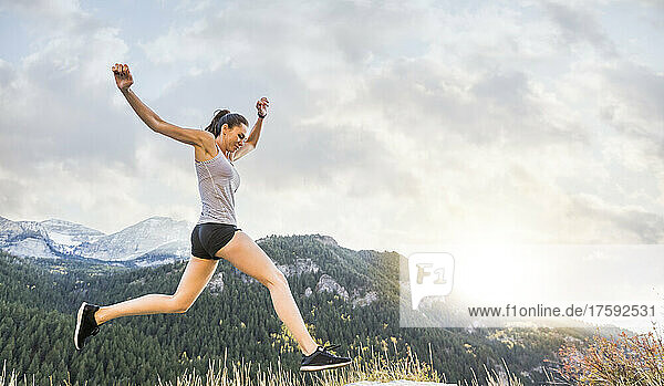 United States  Utah  American Fork  Woman jogging in mountain landscape at sunset