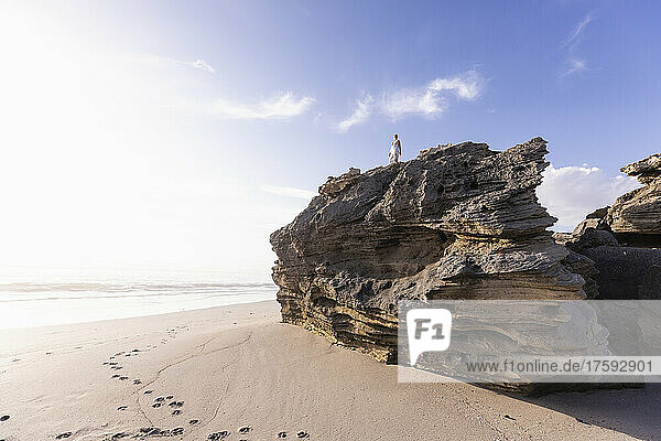 South Africa  Hermanus  Girl (16-17) exploring rock formations on Sopiesklip beach in Walker Bay Nature Reserve