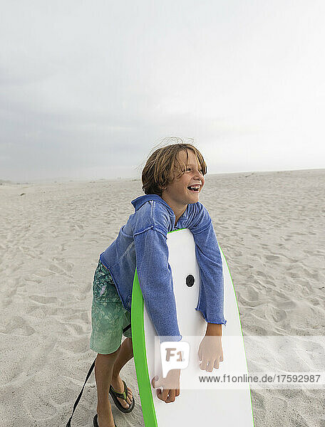 Boy (8-9) with body board on Grotto Beach