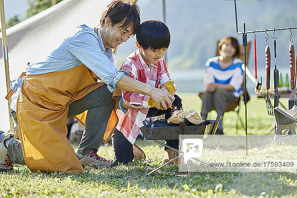 Japanese Parent And Child Making A Fire