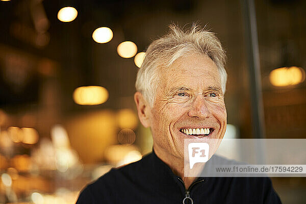 Smiling senior man in cafe