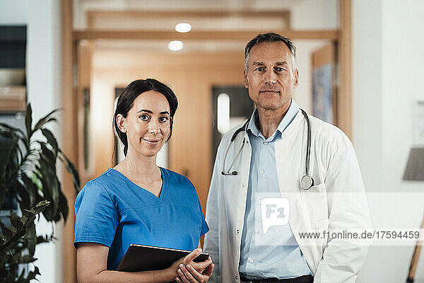 Confident doctor and nurse standing at hospital