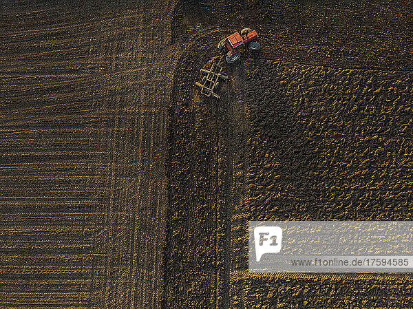 Drone view of tractor plowing field