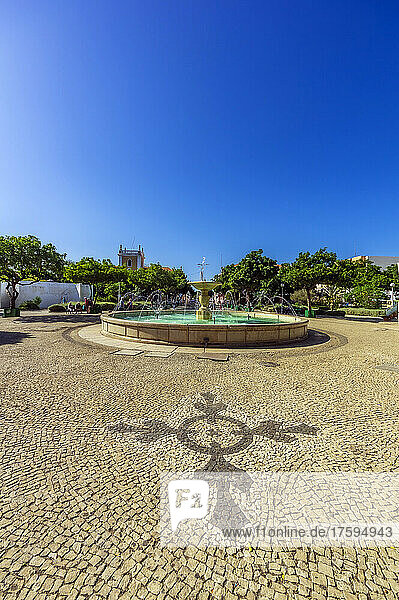 Cape Verde Â SaoÂ Vicente  Mindelo  Clear summer sky over cobblestone square with fountain in center