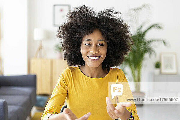 Happy young woman gesturing at home
