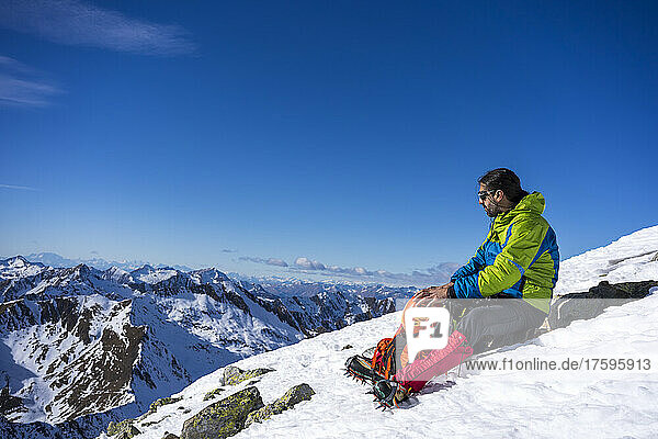 Man resting on snowy mountain at Orobic Alps in Valtellina  Italy