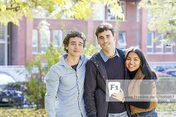 Smiling multiracial friends in college park