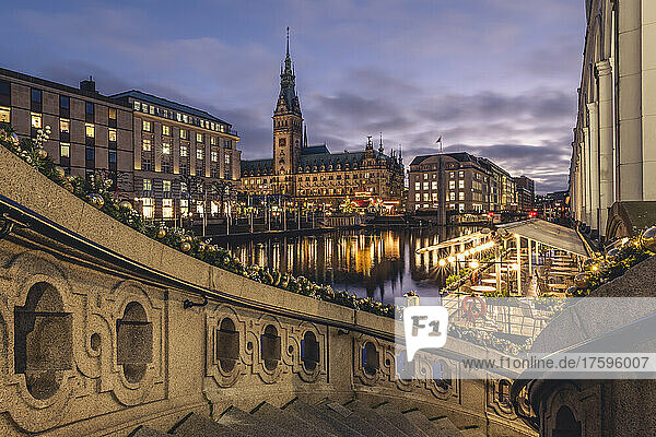 Germany  Hamburg  Exterior staircase at dusk with Kleine Alster and city hall in background