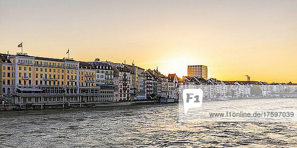 Switzerland  Basel-Stadt  Basel  View of river Rhine at sunset with Les Trois Rois hotel and residential buildings in background