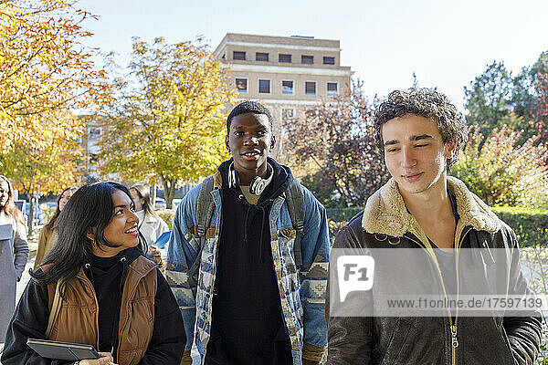 Multiracial friends walking on college campus