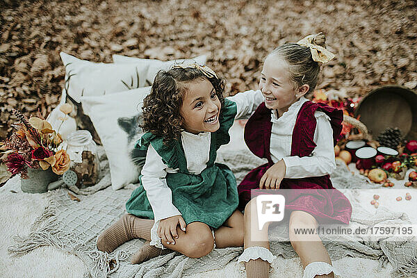 Girls laughing in autumn forest on Christmas