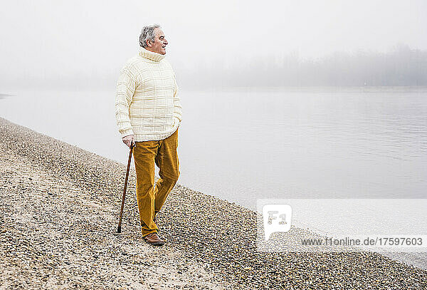 Man with walking cane at beach