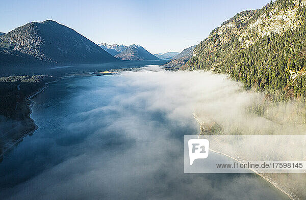 Sylvensteinsee lake amidst mountains in foggy weather  Bad Tolz  Bavaria  Germany