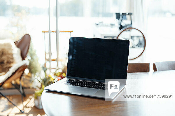 Laptop on wooden table at houseboat