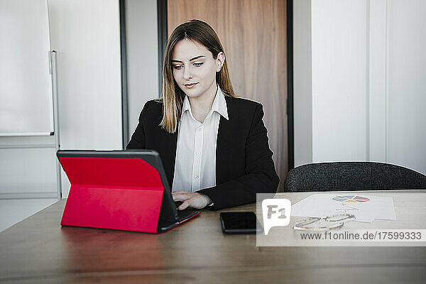 Businesswoman working on tablet PC in office