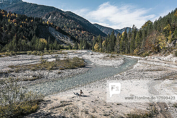 Man sitting by river Rissbach  Hinterriss  Tirol  Austria