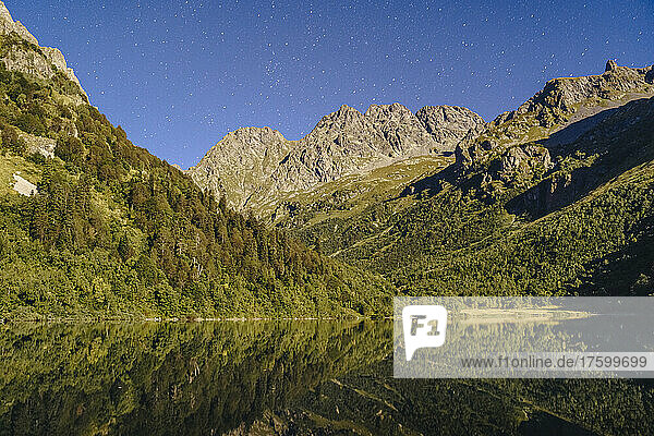 Lake with Caucasus mountain range at night  Sochi  Russia