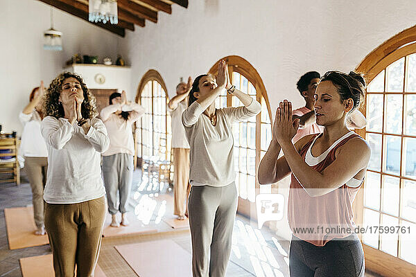Lehrer und Schüler meditieren im Yoga-Studio
