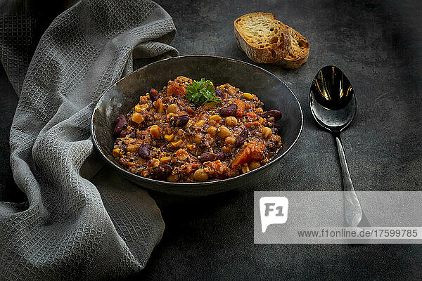 Studio shot of bowl of vegan quinoa stew with vegetables and chick-peas