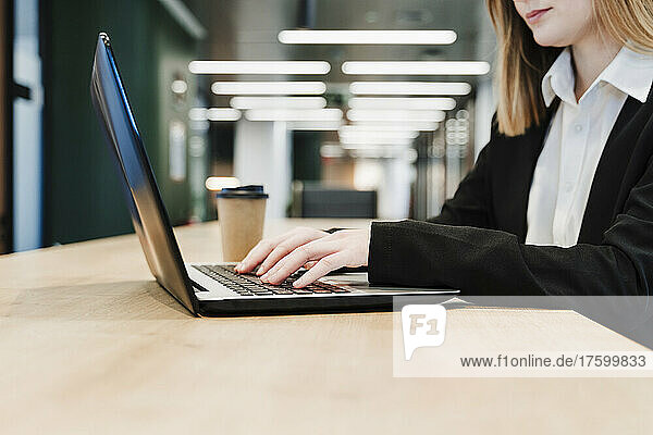 Businesswoman working on laptop in office