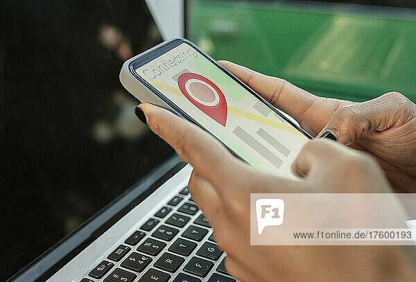 Businesswoman using GPS navigation app on smart phone