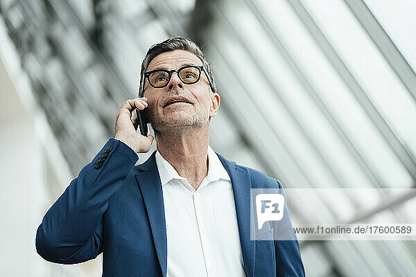 Businessman talking on smart phone at office