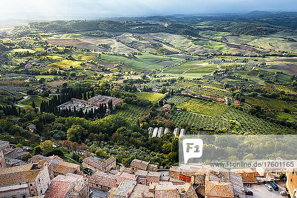 Italy  Province of Siena  Montepulciano  Helicopter view of fields surrounding medieval hill town in Val dOrcia