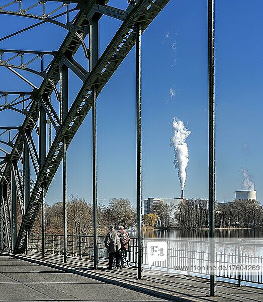 Pedestrians on bridge  the chimneys of the Vattenfall combined heat and power plant on the Havel in Spandau  Berlin  Germany  Europe