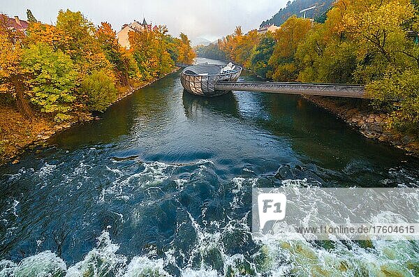 Mur river in autumn  with Murinsel bridge and old buildings in the city center of Graz  Styria region  Austria  Europe