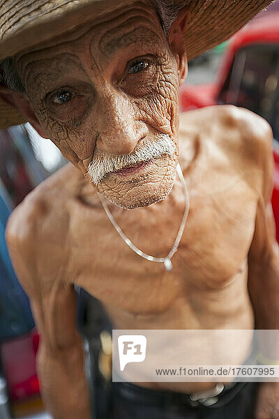 An elderly Cuban man poses for a portrait; Havana  Cuba