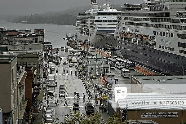 Cruise ships dock at Ketchikan's harbor  while another waits its' turn. In spite of the 200 inches of rain the region receives every year  nearly a million cruise ship passengers visit Alaska  sometimes doubling a town’s population on a summer day. As many as six cruise ships make daily stops and as many as 500 a year. The Inside Passage is a network of channels between islands along the coast of Alaska  British Columbia and Washington state. Tourism is Southeast Alaska’s fastest growing industry. The former logging town of Ketchikan  now relies on tourism. Travelers can shop for native art and souvenirs or diamonds in one of many jewelry stores along what was a former red-light district during the Gold Rush; Ketchikan  Alaska  United States of America
