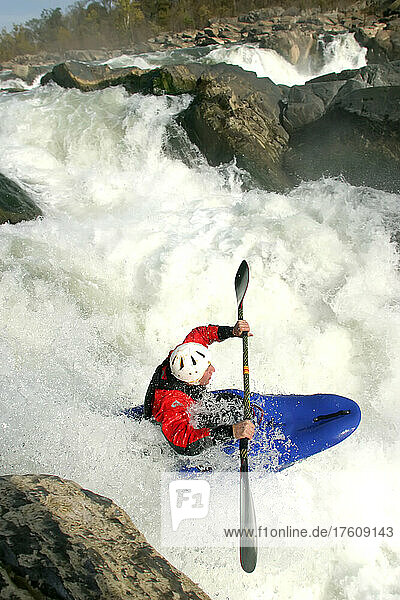 Whitewater kayaker drops a big waterfall.; Great Falls  Potomac River  Virginia/Maryland.