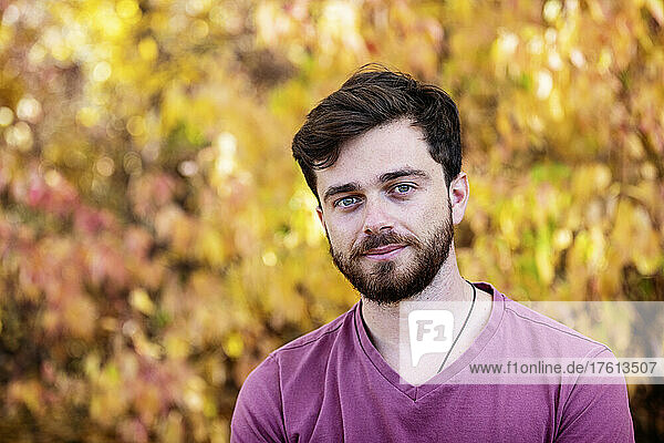 Head and shoulders portrait of a man outdoors in a park in autumn; Edmonton  Alberta  Canada