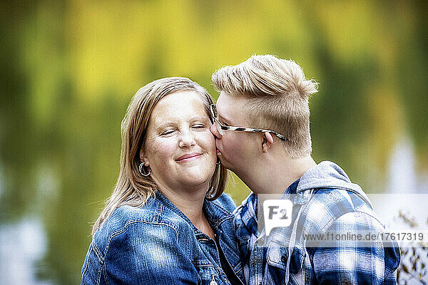 A mother and her son who has Down Syndrome spending quality time together in a city park; Edmonton  Alberta  Canada