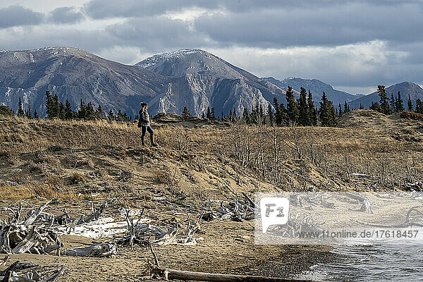 Woman standing on the dunes on the shores of Bennett Lake; Carcross  Yukon  Canada