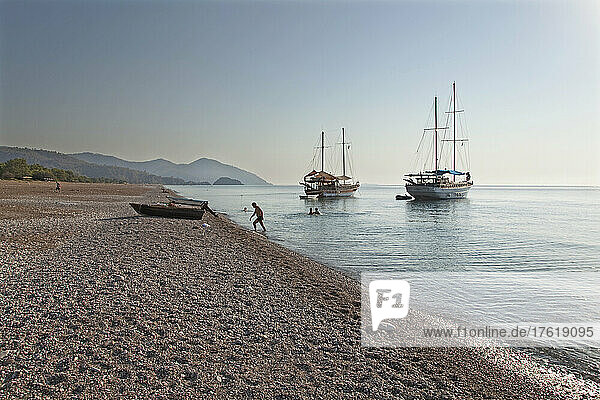 Early morning view of Gulets moored off Cirali beach  Turkey; Cirali  Antalya Province  Turkey