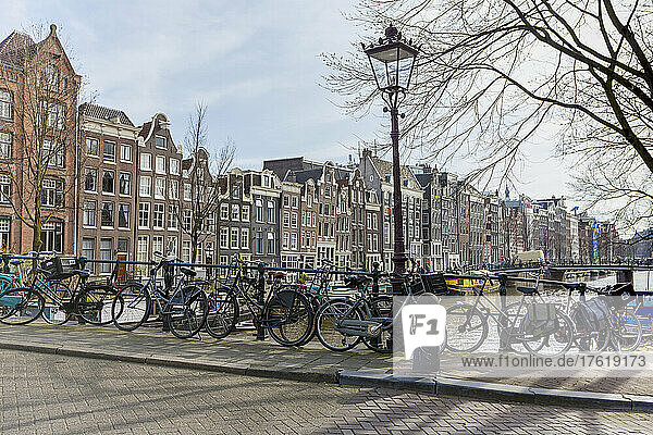 Bicycles parked on canal bridge  Singel in Amsterdam; Amsterdam  North Holland  Netherlands