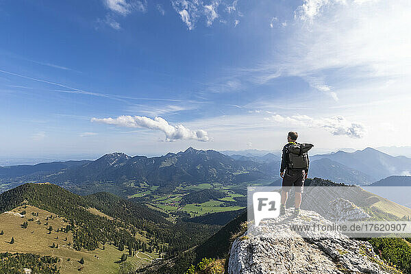 Male hiker admiring view from summit of Aiplspitz mountain