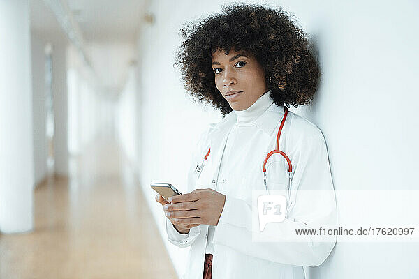 Doctor with mobile phone at medical clinic