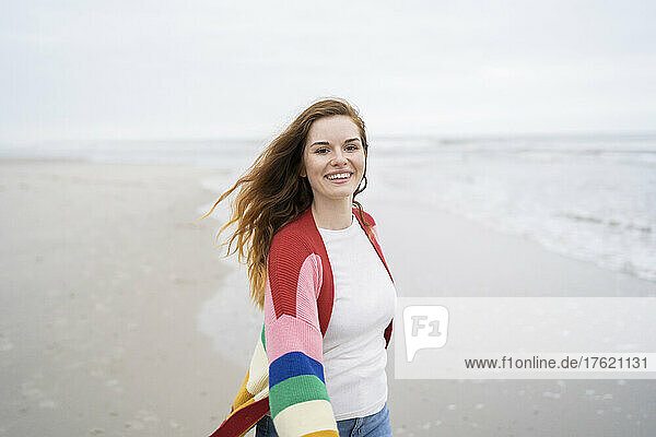 Happy woman with long hair enjoying at beach