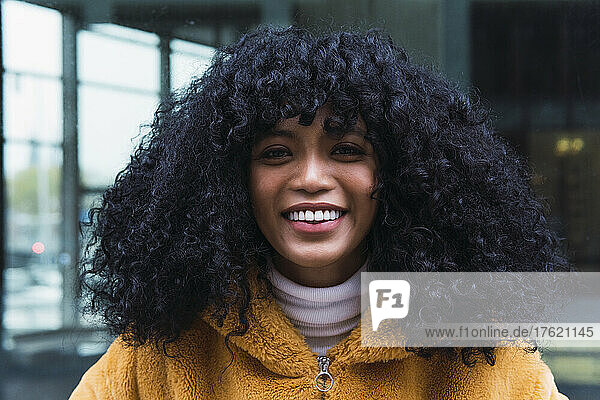 Smiling woman with black curly hair