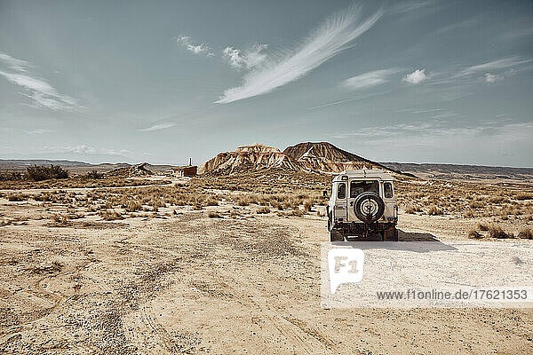 Car driving in desert landscape  Bardenas Reales  Spain