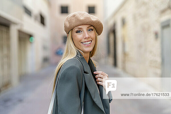 Smiling beautiful woman with long blond hair wearing beret