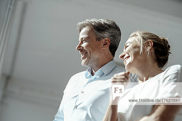 Happy businessman and businesswoman together in office