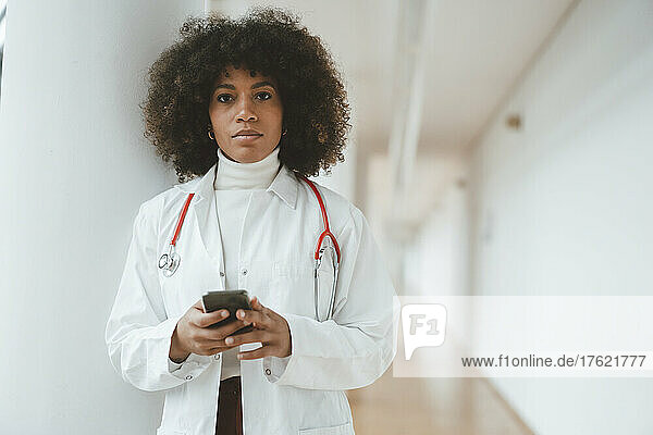 Doctor with smart phone at medical clinic