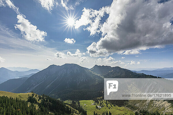 Summer sun shining over valley in Alps