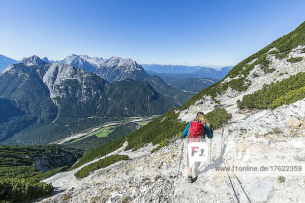 Female hiker descending Brunnensteinspitze mountain in summer
